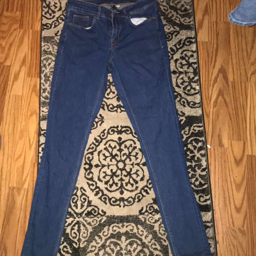 One pair of simple, lightly worn jeans.